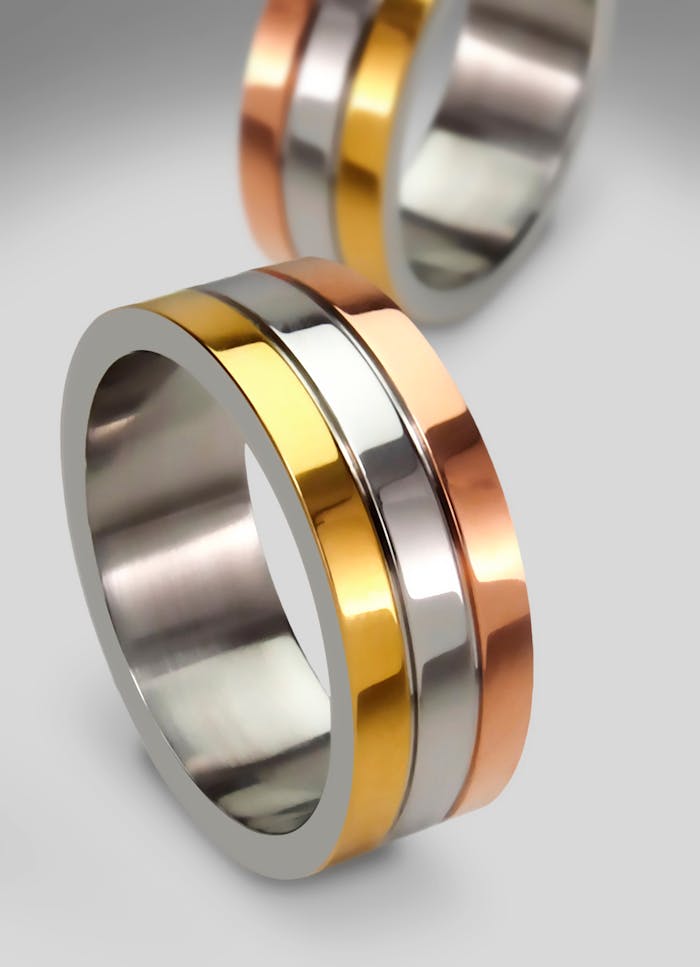 Services Elegant tri-color gold rings showcasing modern design, perfect for engagements or weddings.